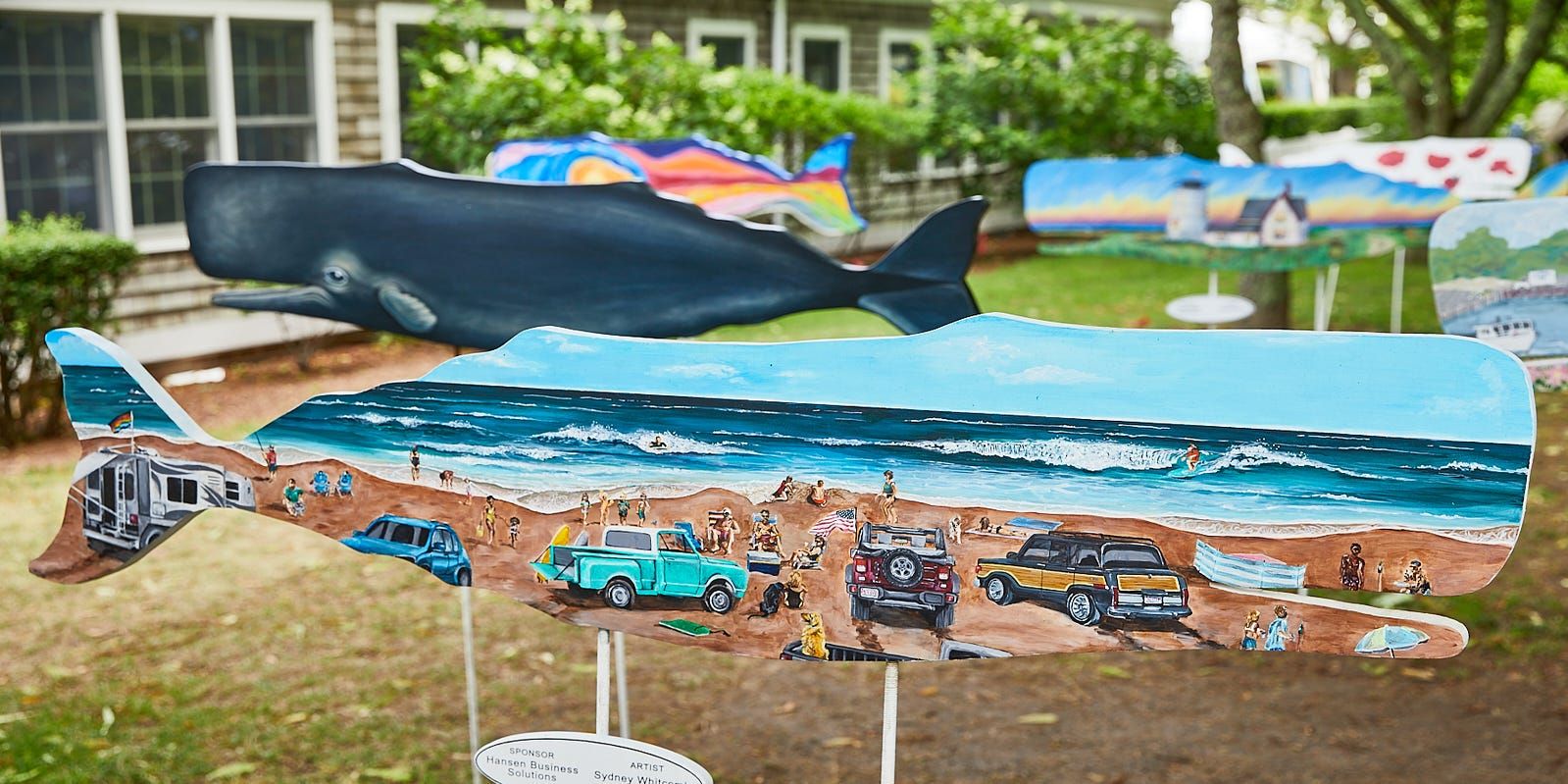 Collection of whale artpieces in a park